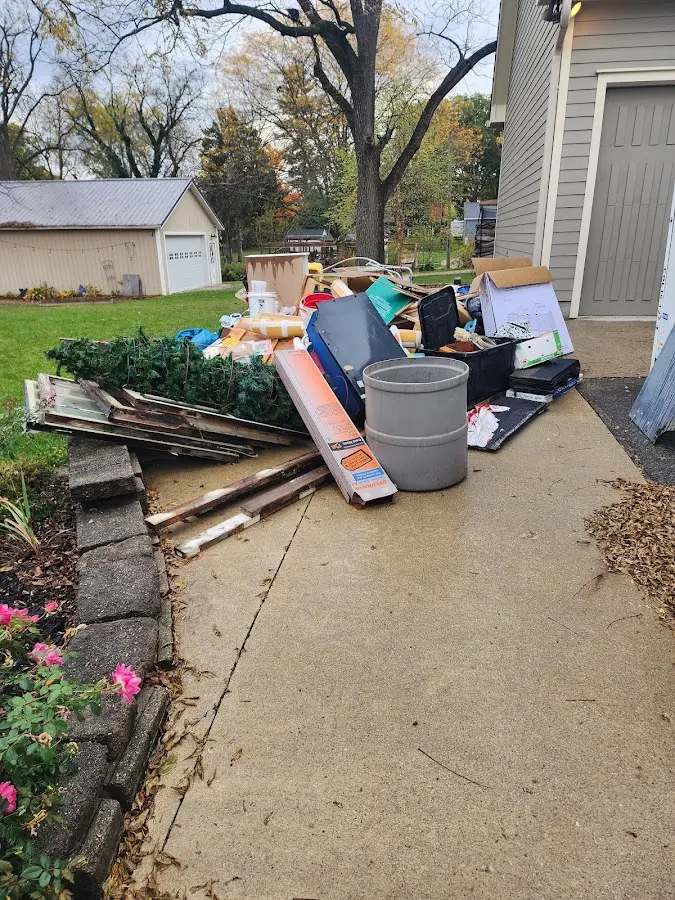 Dumpster being loaded with debris for Residential Dumpster Rental in Smithville
